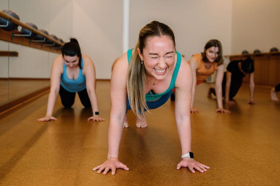 Barre and movement classes in Boston studios, showcasing strength, flexibility, and community-focused workouts.
